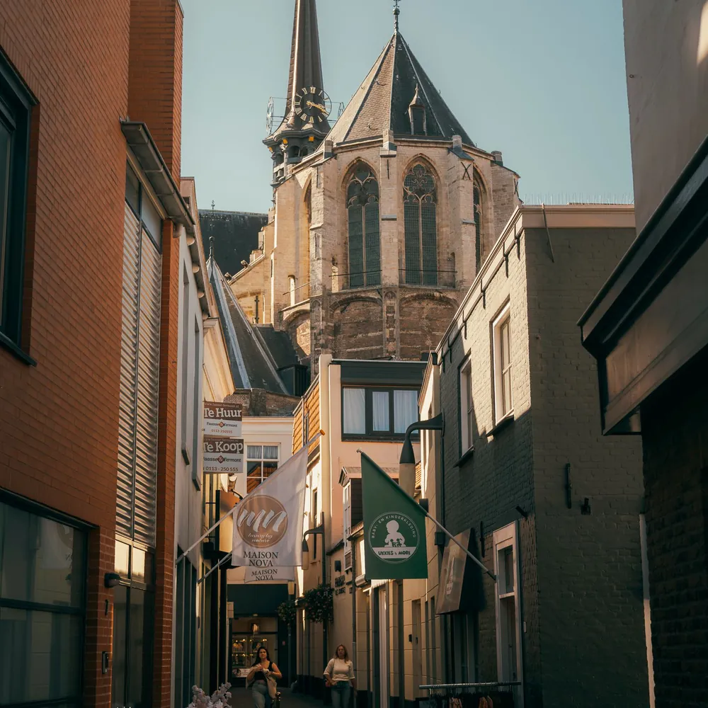 Een steegje met de kerk in Goes, waar je de rijscholen in Goes kunt vergelijken